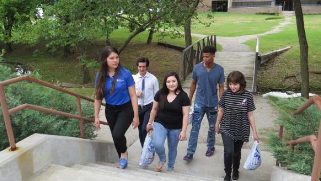 students walking on a path among the trees on TCC Northeast Campus